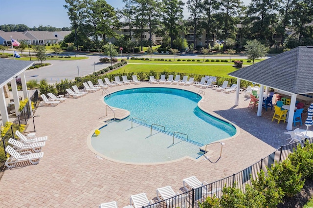 view of swimming pool with a lawn and a patio