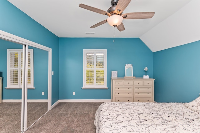 carpeted bedroom with lofted ceiling, a closet, and ceiling fan