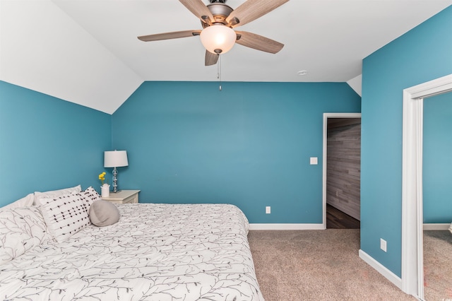 unfurnished bedroom with ceiling fan, lofted ceiling, and carpet flooring