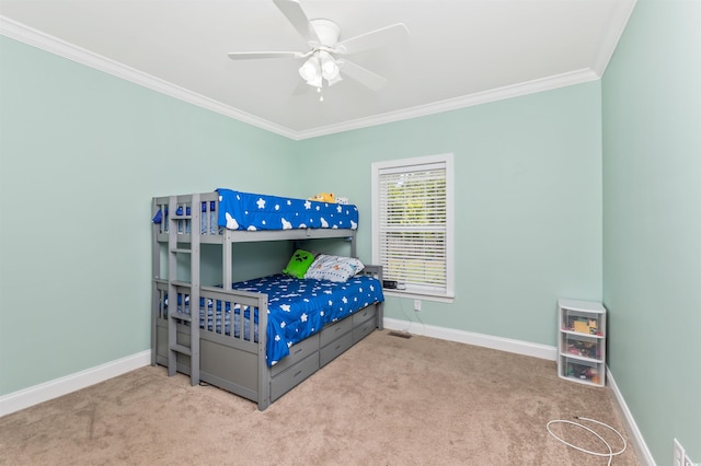 bedroom featuring carpet, crown molding, and ceiling fan