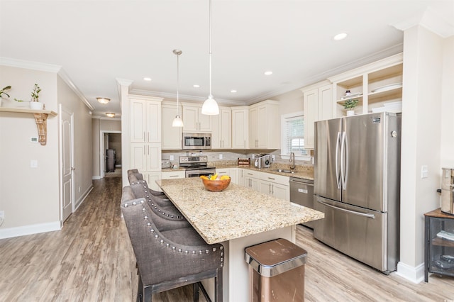 kitchen with light stone countertops, pendant lighting, stainless steel appliances, a kitchen bar, and a center island