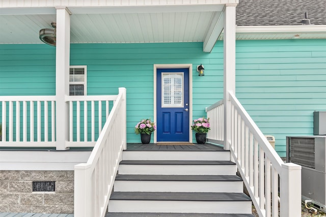 view of exterior entry featuring covered porch