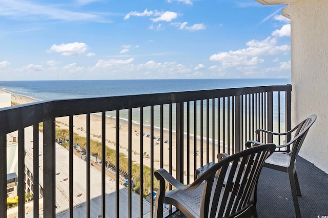 balcony with a water view and a beach view