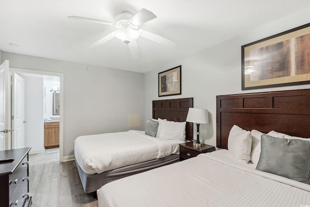 bedroom with ceiling fan, ensuite bathroom, and light hardwood / wood-style floors