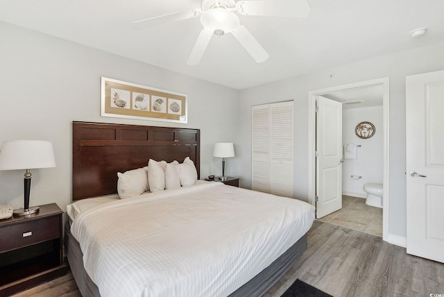 bedroom with connected bathroom, hardwood / wood-style floors, ceiling fan, and a closet