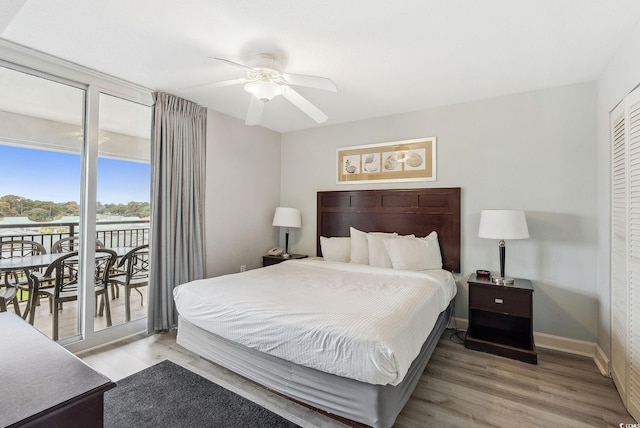 bedroom with access to outside, light hardwood / wood-style flooring, a closet, and ceiling fan