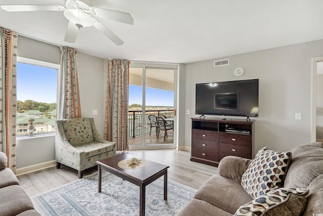 living room featuring ceiling fan and light hardwood / wood-style flooring