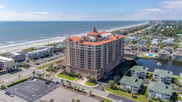 bird's eye view featuring a view of the beach and a water view