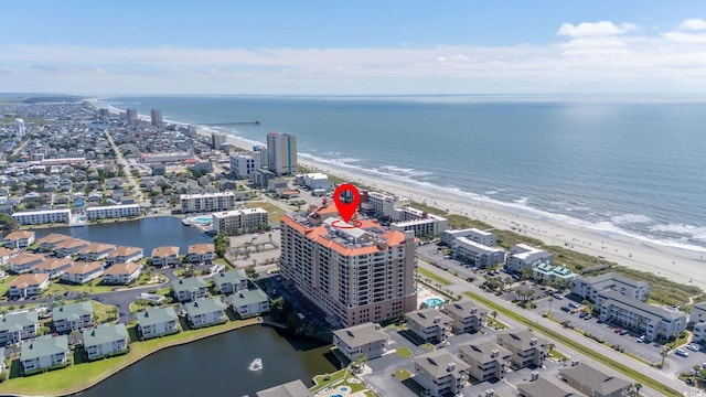 bird's eye view featuring a water view and a beach view