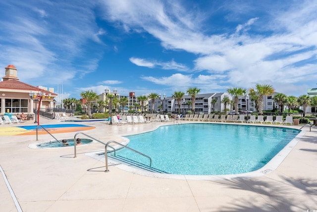 view of swimming pool featuring a community hot tub and a patio area