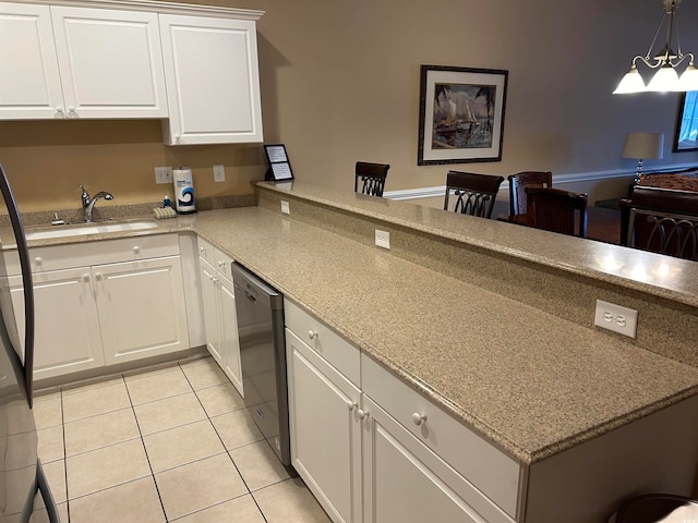 kitchen featuring sink, white cabinetry, light tile patterned floors, decorative light fixtures, and stainless steel dishwasher