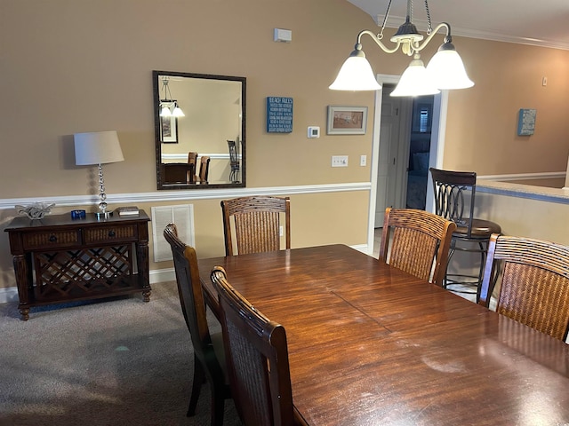 dining space featuring crown molding, hardwood / wood-style floors, and an inviting chandelier