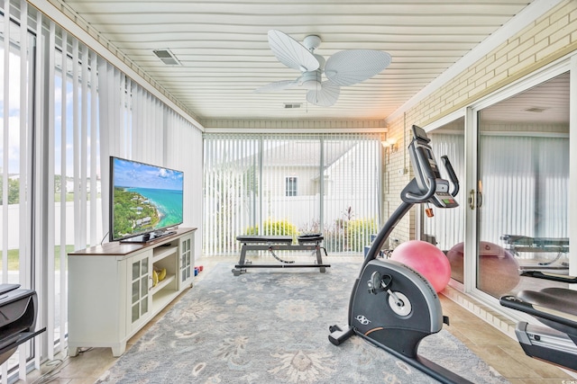 workout room featuring ceiling fan, wooden ceiling, and a healthy amount of sunlight