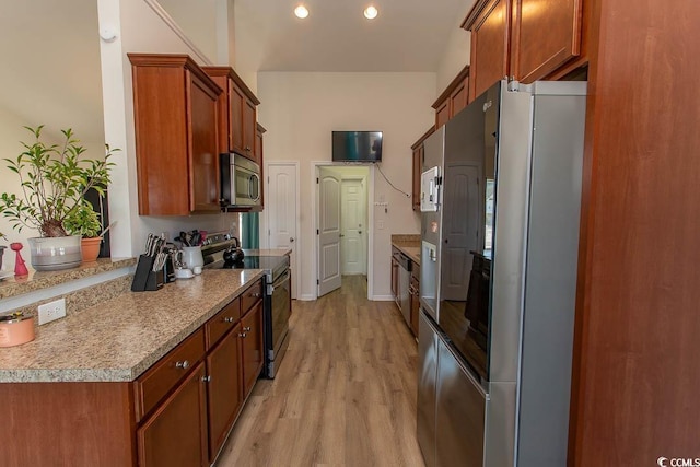 kitchen with light wood-type flooring and appliances with stainless steel finishes