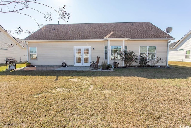 rear view of property with french doors, a yard, and a patio area