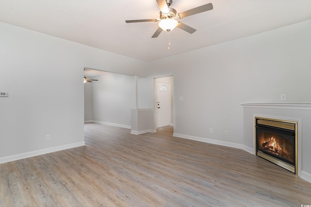 unfurnished living room with ceiling fan and light hardwood / wood-style floors