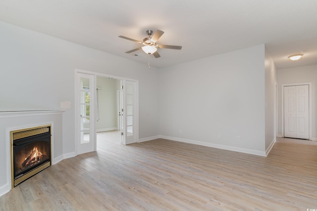 unfurnished living room with ceiling fan and light hardwood / wood-style flooring