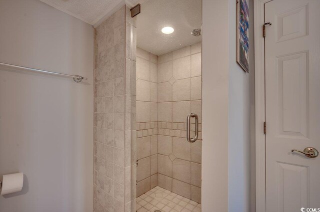 bathroom featuring a textured ceiling and walk in shower