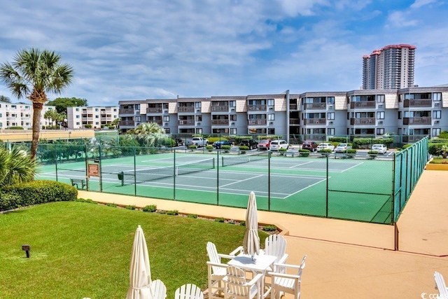 view of sport court with a lawn