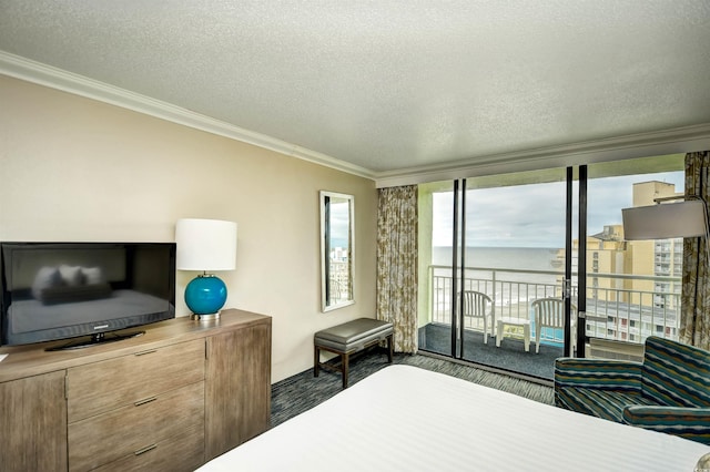 1105 S Ocean Blvd Unit 1044, Myrtle Beach, SC 29577 - bedroom with access to exterior, crown molding, a textured ceiling, a water view, and expansive windows