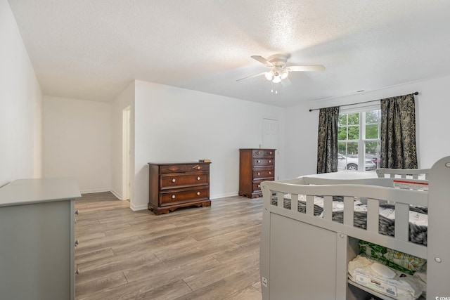 1356 Tranquility Ln, Myrtle Beach, SC 29577 - bedroom with light wood-type flooring, a textured ceiling, and ceiling fan