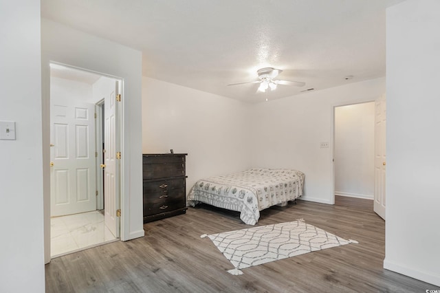 bedroom with light hardwood / wood-style floors and ceiling fan