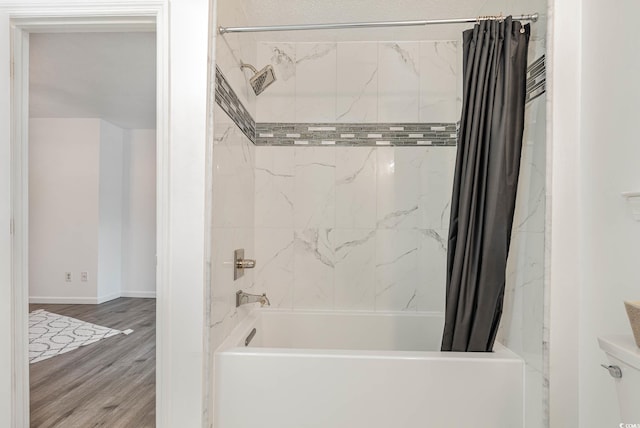 bathroom with wood-type flooring and shower / bathtub combination with curtain