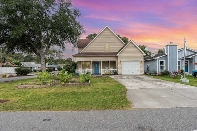 view of front facade with a yard, a porch, and a garage