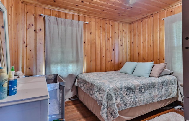 bedroom with wood ceiling, wood walls, and hardwood / wood-style floors