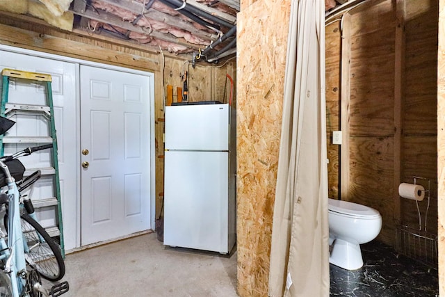 interior space featuring concrete flooring and toilet