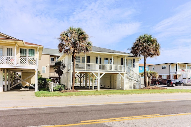 coastal inspired home with a carport and covered porch