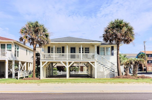 coastal inspired home featuring a porch and a carport