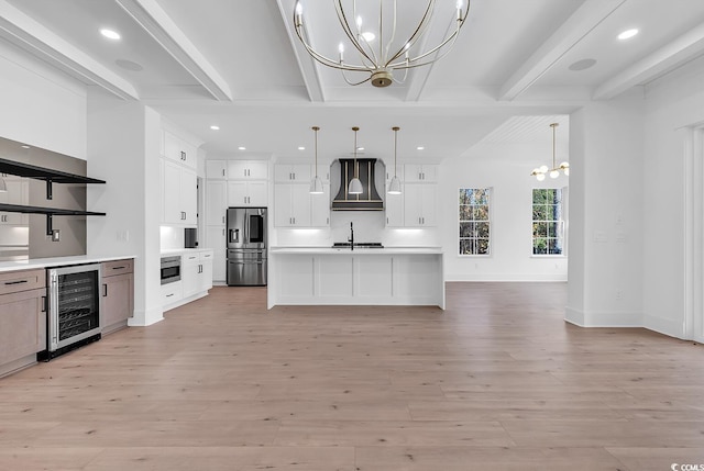 kitchen with beam ceiling, white cabinets, pendant lighting, and a notable chandelier