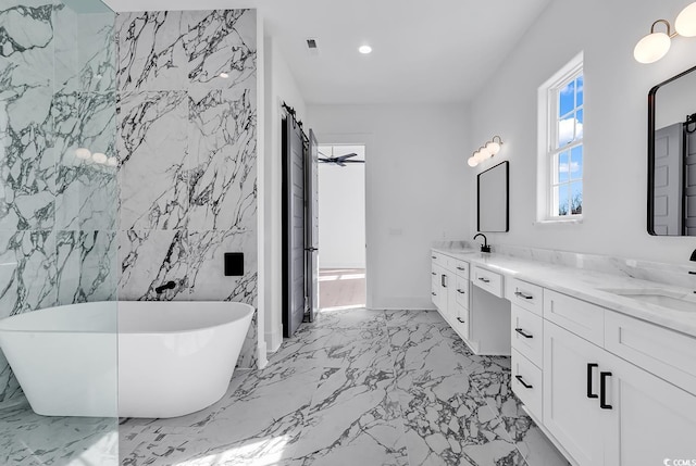 bathroom featuring a bathing tub, ceiling fan, vanity, and tile walls