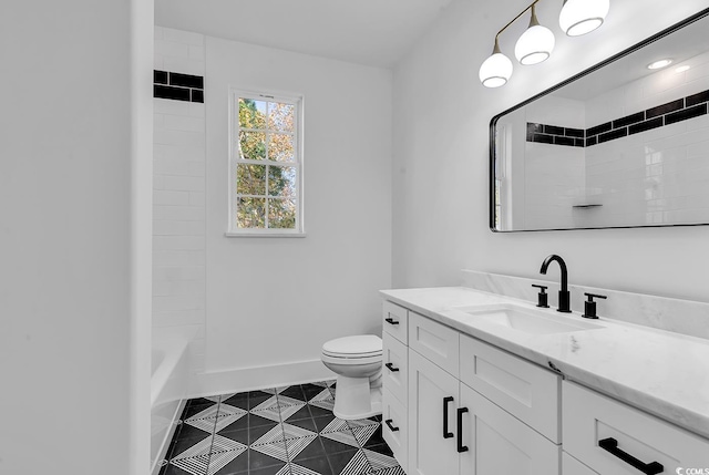 full bathroom with tile patterned flooring, vanity, toilet, and tiled shower / bath combo