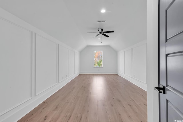 bonus room with ceiling fan, light wood-type flooring, and vaulted ceiling