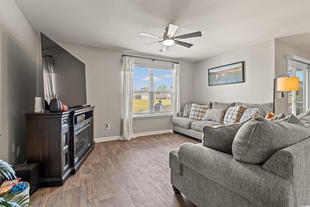 living room with ceiling fan and dark hardwood / wood-style floors