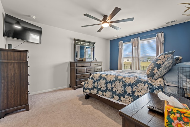 bedroom featuring light colored carpet and ceiling fan