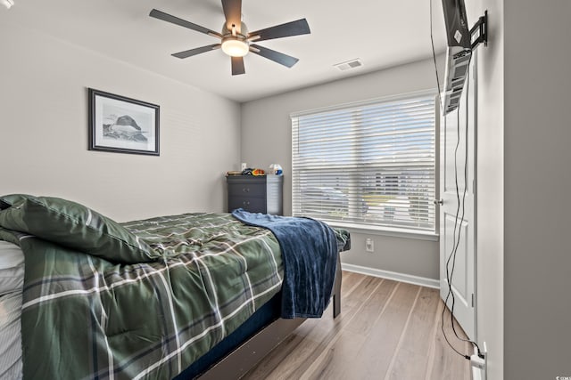 bedroom with ceiling fan and light wood-type flooring