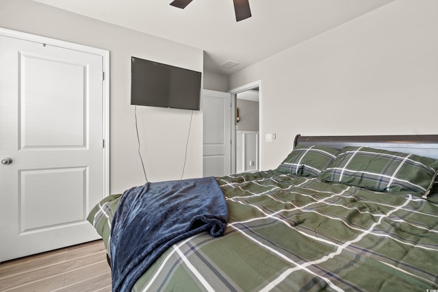 bedroom with wood-type flooring and ceiling fan