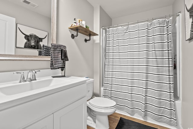 full bathroom featuring toilet, vanity, shower / bath combination with curtain, and hardwood / wood-style flooring