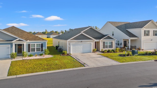 craftsman-style house with central AC unit, a front yard, and a garage