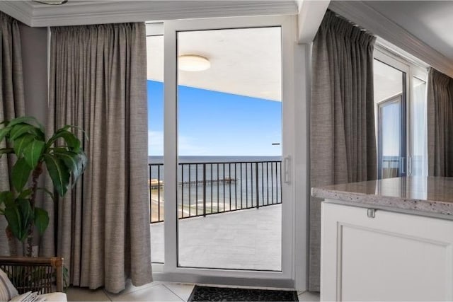 entryway with a water view and light tile patterned floors