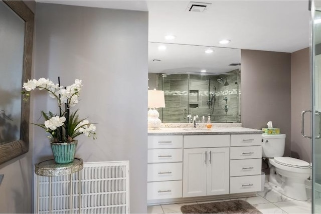 bathroom featuring vanity, an enclosed shower, and toilet