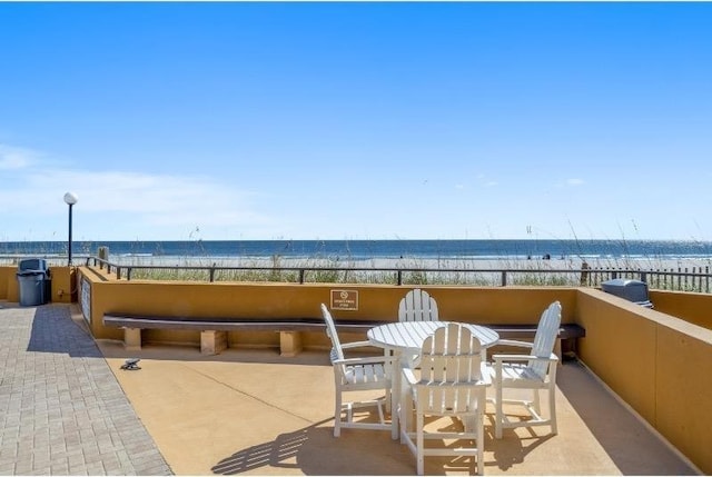 view of patio / terrace with a view of the beach and a water view