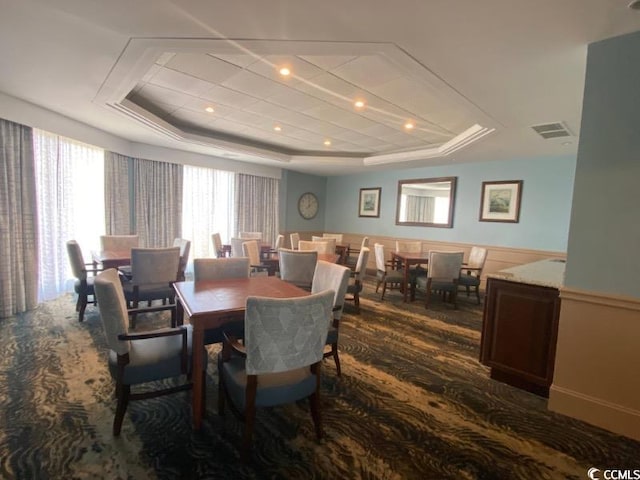 dining area with a tray ceiling