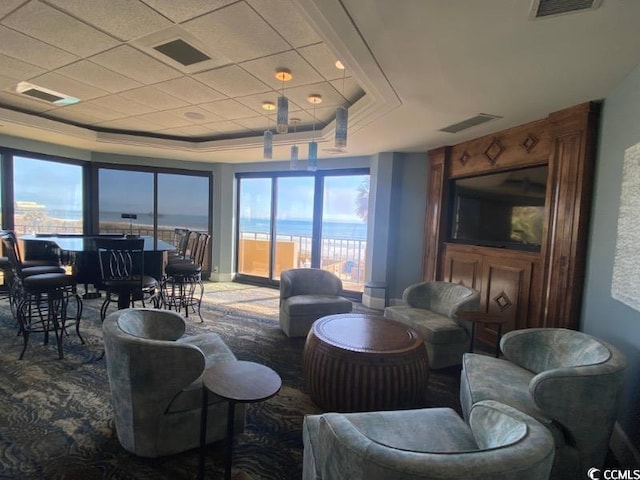 carpeted living room featuring a raised ceiling