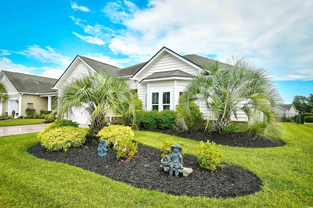 exterior space featuring a front yard and a garage