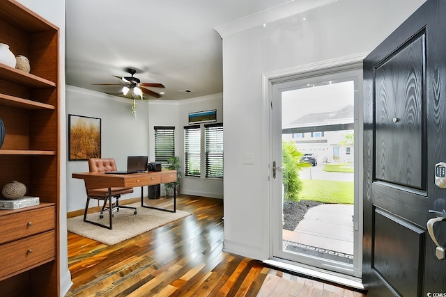 office space featuring ornamental molding, ceiling fan, and dark wood-type flooring