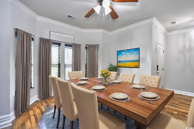 dining area featuring dark hardwood / wood-style flooring, ceiling fan, and ornamental molding